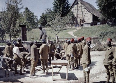 A group of Senegalese soldiers serving in the French Army as infantrymen having lunch in Saint-Ulrich, Department Haut-Rhin, Alsace, France, June 16, 1917 by Paul Castelnau